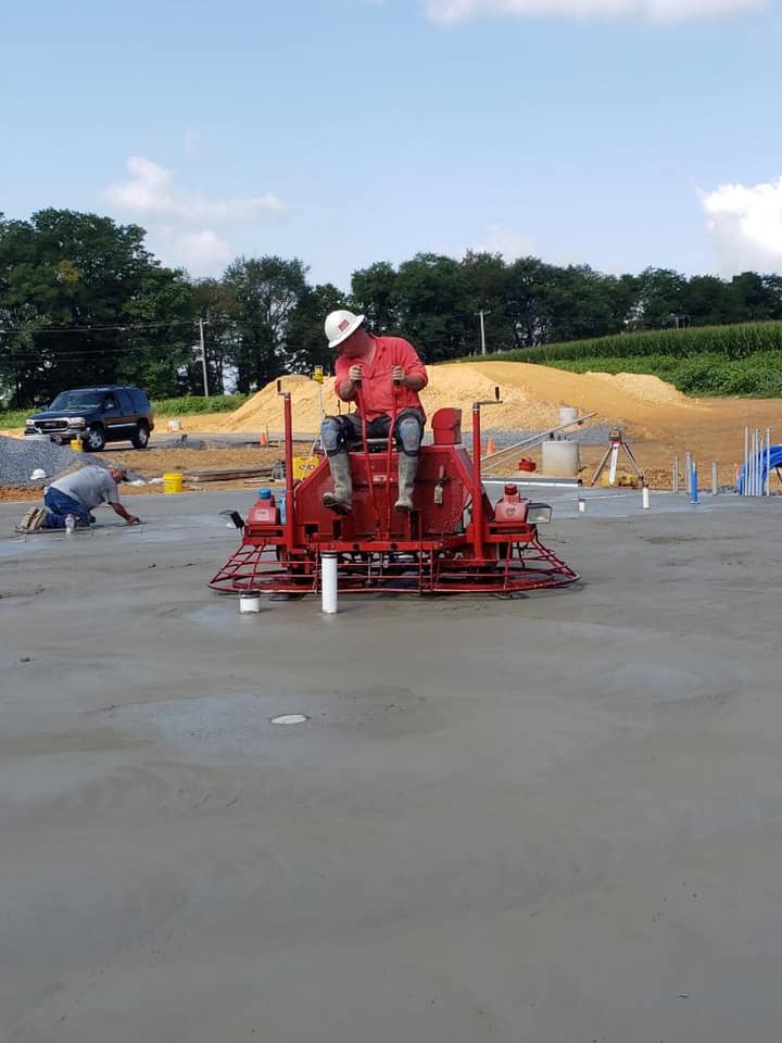Ride-on power trowel finishing a concrete floor